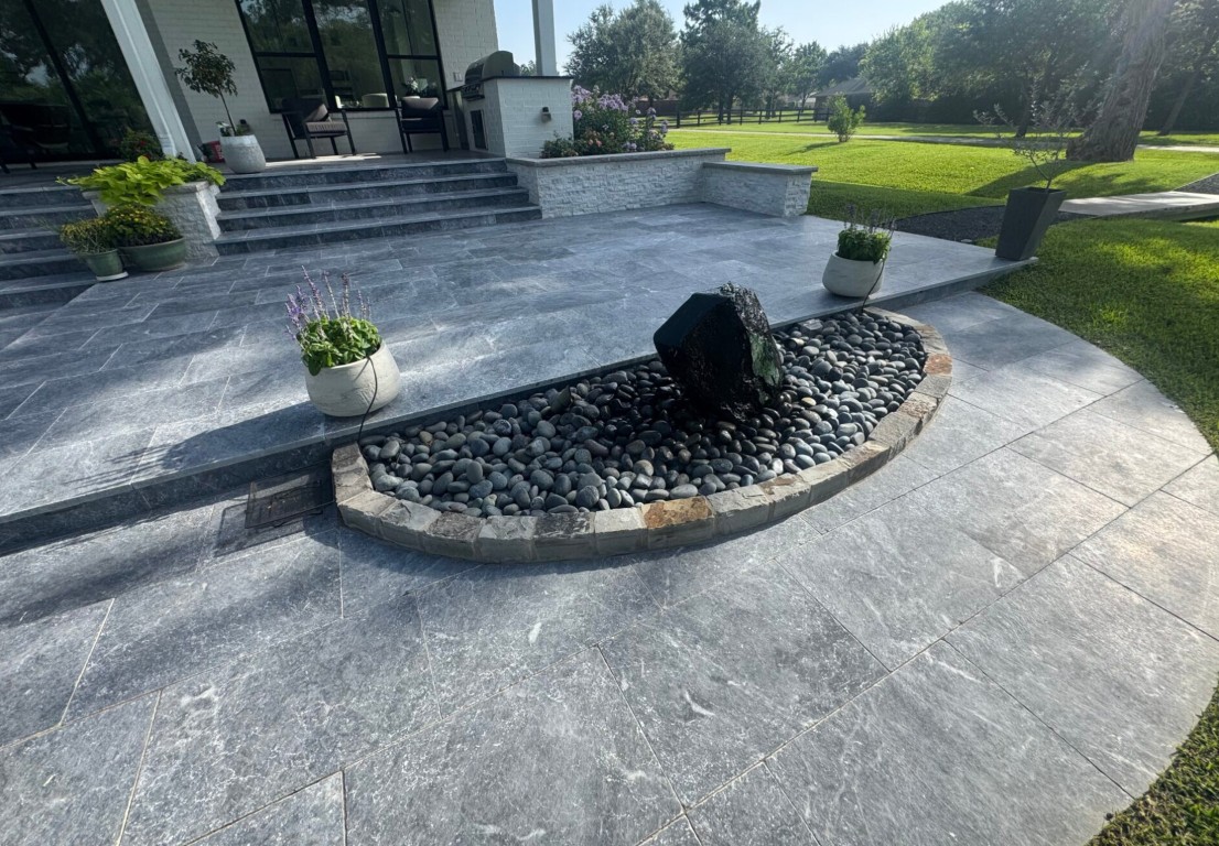 Stamped concrete patio with water feature and modern landscaping in Bradenton, FL